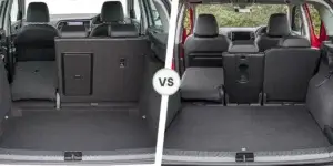 A comparison of the cargo areas of a SEAT Arona and a Skoda Kamiq. The left side shows the cargo area of the SEAT Arona, with the rear seats folded down to reveal a flat loading floor. The right side shows the cargo area of the Skoda Kamiq, also with the rear seats folded down to reveal a flat loading floor. The two cargo areas are separated by the word "VS.