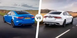 A side-by-side comparison of two Jaguar cars, the Jaguar XF and XE. The car on the left is blue and has a sportier design with larger wheels and a more aggressive rear bumper. The car on the right is white and has a more elegant design with smaller wheels and a less aggressive rear bumper.