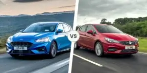 A side-by-side comparison of two cars. On the left is a blue Ford Focus, and on the right is a red Vauxhall Astra. Both cars are driving on a road with a scenic landscape in the background.