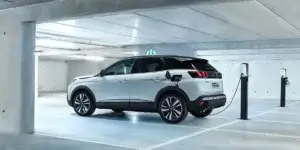 An electric car charging at a station in an underground parking lot.