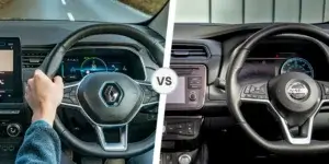 A side-by-side comparison of the interiors of a Renault Zoe and a Nissan Leaf. The left side shows the interior of a Renault Zoe, with a blue and silver steering wheel and a digital instrument cluster. The right side shows the interior of a Nissan Leaf, with a black steering wheel and a traditional analog instrument cluster.