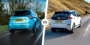 A side-by-side comparison of a Renault Zoe and a Nissan Leaf. The left side shows a blue Renault Zoe driving down a road. The right side shows a white Nissan Leaf driving down a road. The cars are facing each other.