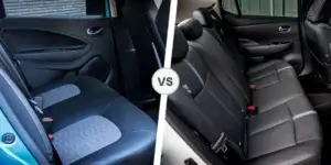  A side-by-side comparison of the backseats of a Renault Zoe and a Nissan Leaf. The left side shows the backseat of a Renault Zoe with two passengers seated. The right side shows the backseat of a Nissan Leaf with three passengers seated.