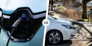 A side-by-side comparison of a Renault Zoe and a Nissan Leaf. The left side shows a close-up of a Renault Zoe charging cable plugged into the car's charging port. The right side shows a Nissan Leaf parked at a charging station with the charging cable plugged in.