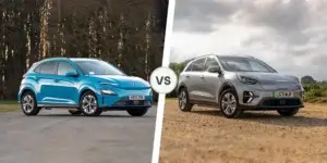 A side-by-side comparison of the Hyundai Kona Electric and Kia e-Niro. The Hyundai Kona Electric is blue and driving on a paved road. The Kia e-Niro is silver and driving on a dirt road. Both cars are driving in a rural setting with green fields and trees in the background.