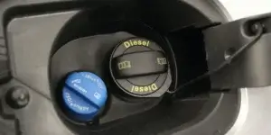 Close-up of a car's dashboard display showing a warning message indicating that AdBlue needs to be refilled. The message is displayed in a white font against a black background, highlighting the importance of maintaining the AdBlue level in the vehicle.