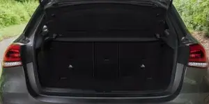 The open boot of a Mercedes-Benz A-Class car. The trunk is empty and has a spacious interior with a flat load floor. The rear taillights are visible on either side of the trunk opening.