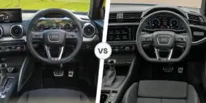 A side-by-side comparison of the interiors of two Audi Q2 cars. The interior on the left has a more modern design with a larger touchscreen display and a digital instrument cluster. The interior on the right has a sportier design with a smaller touchscreen display and analog gauges. Both interiors have black dashboards and steering wheels.