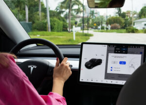 A cockpit with LCD touch screen of electric car Tesla Model Y during drive in Miami, USA. Tesla electric cars are produced by Tesla Motors, Inc. in California, USA.