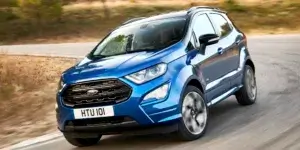 A blue Ford EcoSport driving on a winding road.