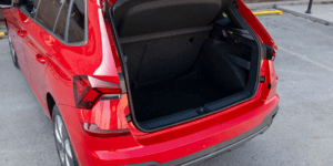 Rear view of a red Škoda Kamiq with the boot open to reveal the cargo space