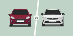 A side-by-side comparison of two cars. On the left is a red Ford Fiesta, and on the right is a white Vauxhall Corsa. Both cars are facing the camera.